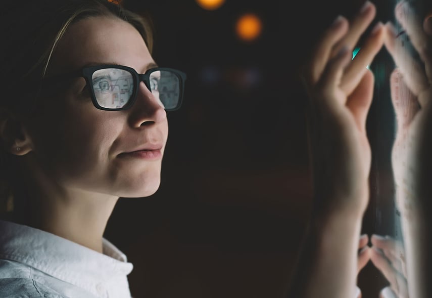 Eine Frau tippt auf einen Bildschirm und sortiert gesetzliche und regulatorische Veränderungen, die mit Hilfe eines Change-Managements umgesetzt werden